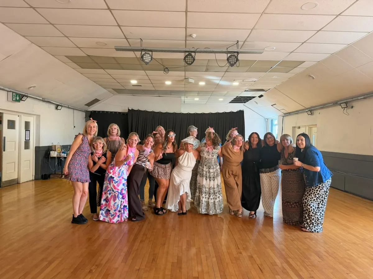 Hen party group mid-routine in their burlesque dance class